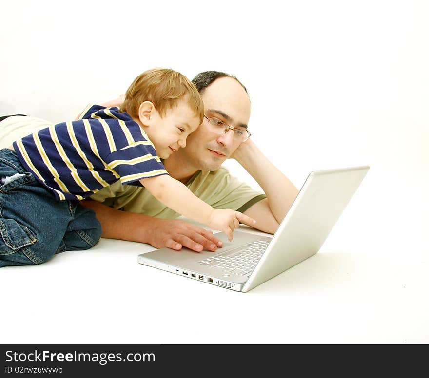 Father and son with laptop over white