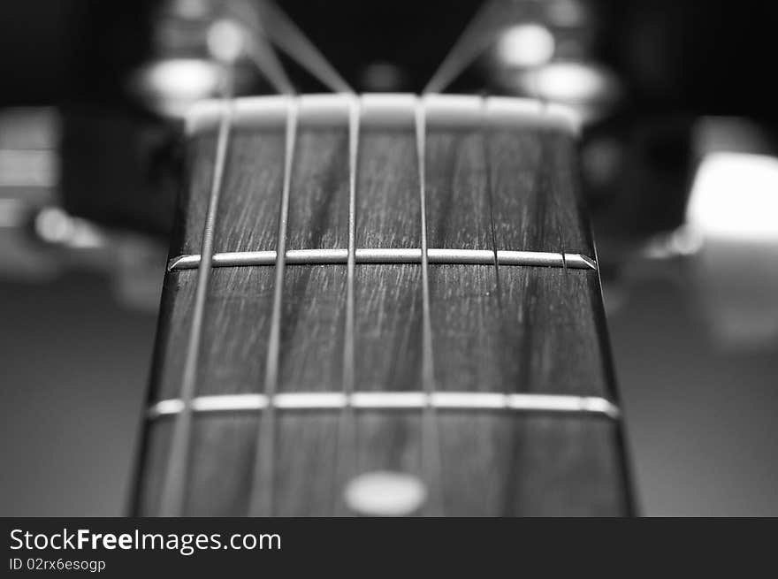 Macro of the 1st fret of a guitar.