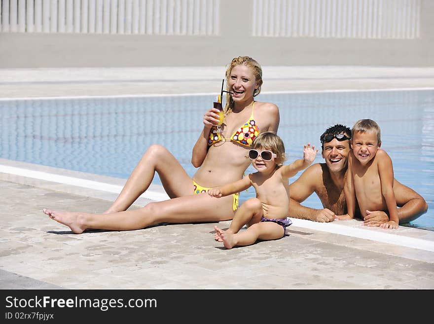 Happy young family have fun on swimming pool  at summer vacation