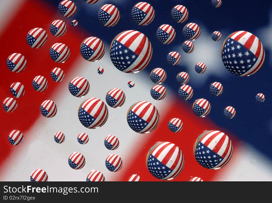 This is a refraction in the water. The water drops are on a piece of glass suspended a foot or so above an American Flag. This is a refraction in the water. The water drops are on a piece of glass suspended a foot or so above an American Flag