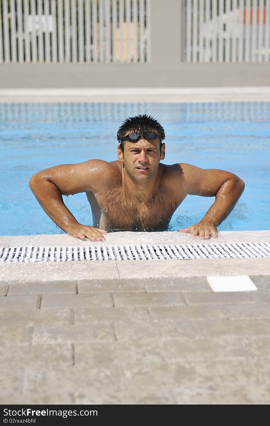 Young athlete man relax at swimming pool. Young athlete man relax at swimming pool