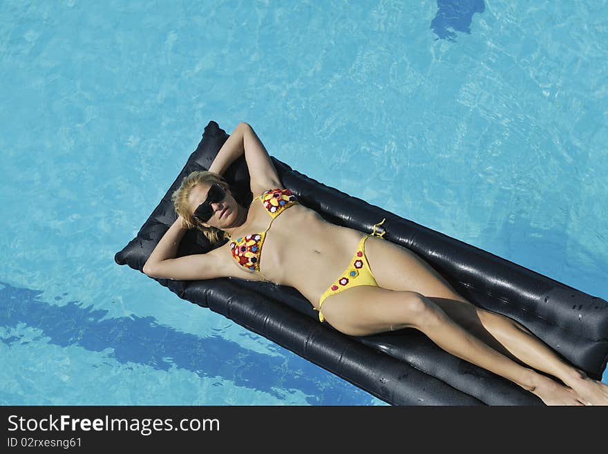 Beautiful young woman enjoy sun and coctail dring relaxing and have fun at siwmming pool. Beautiful young woman enjoy sun and coctail dring relaxing and have fun at siwmming pool