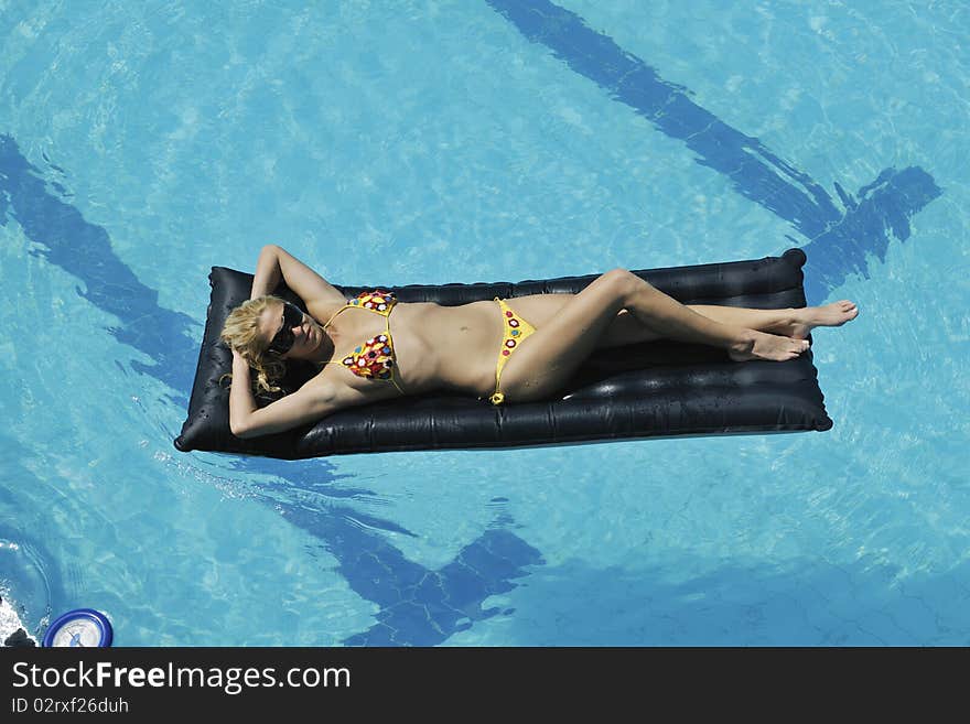 Beautiful young woman enjoy sun and coctail dring relaxing and have fun at siwmming pool. Beautiful young woman enjoy sun and coctail dring relaxing and have fun at siwmming pool