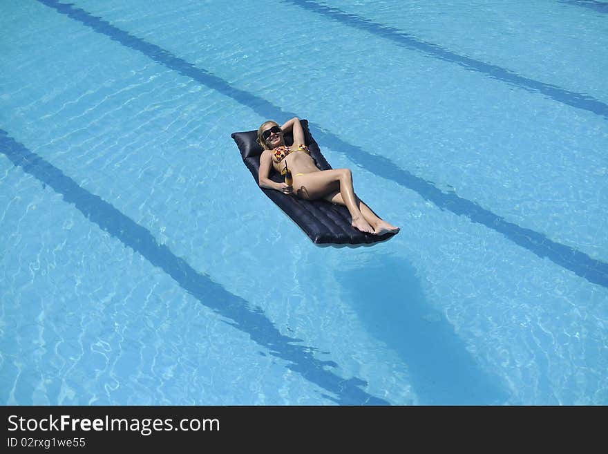 Beautiful young woman enjoy sun and coctail dring relaxing and have fun at siwmming pool. Beautiful young woman enjoy sun and coctail dring relaxing and have fun at siwmming pool