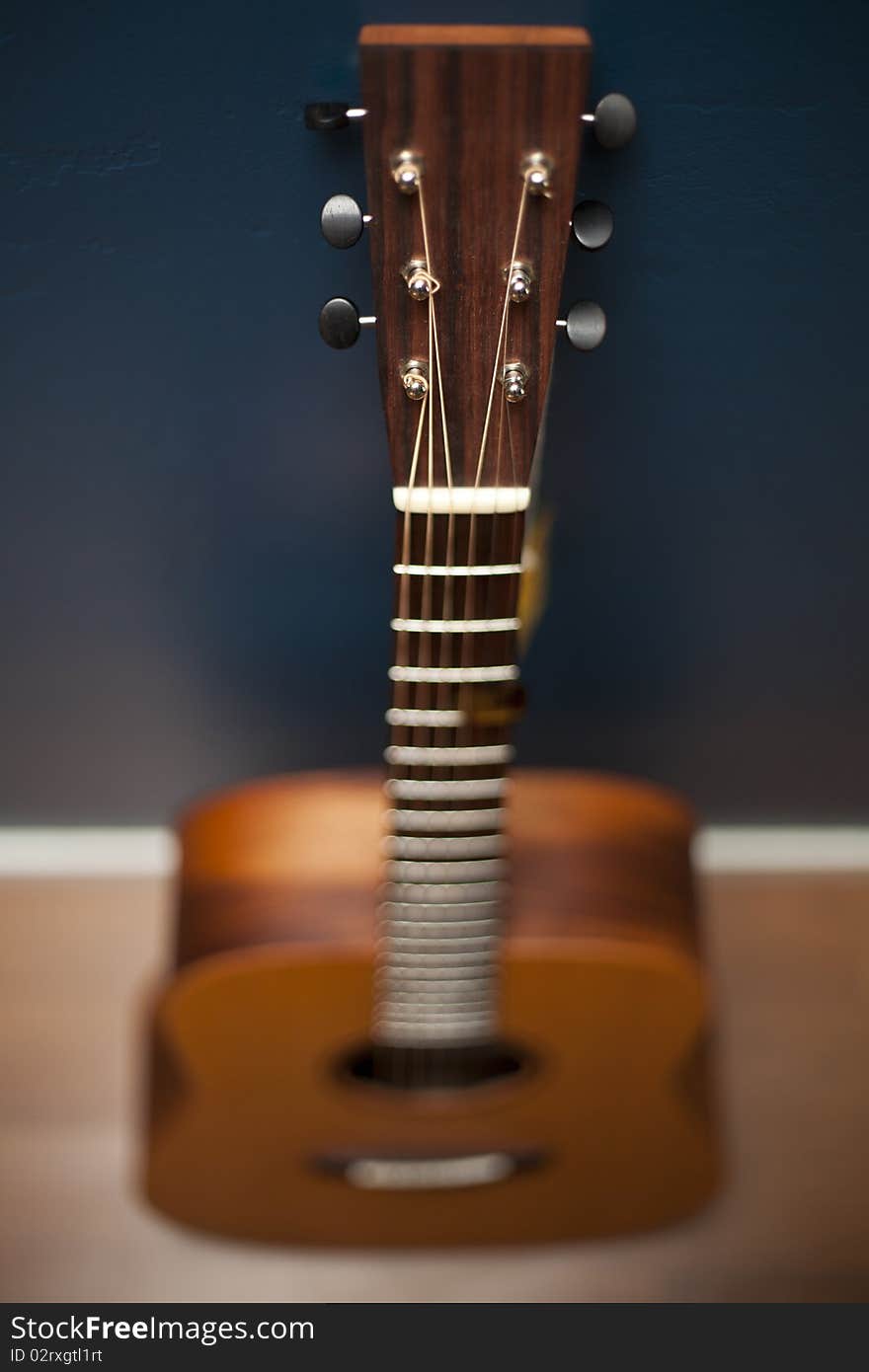 Guitar Against a Blue Wall