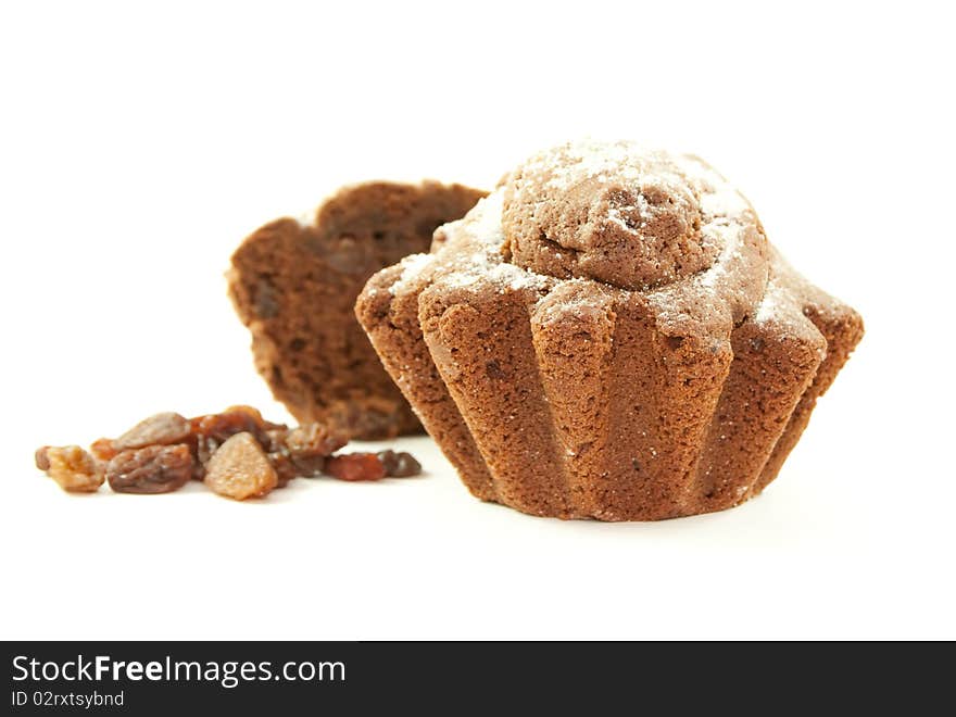 Brown home baked cupcake with raisins. Isolated on white background