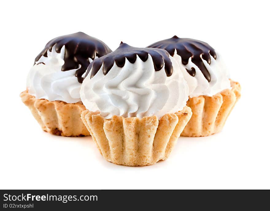 Muffins on a white background with cream and chocolate. Muffins on a white background with cream and chocolate