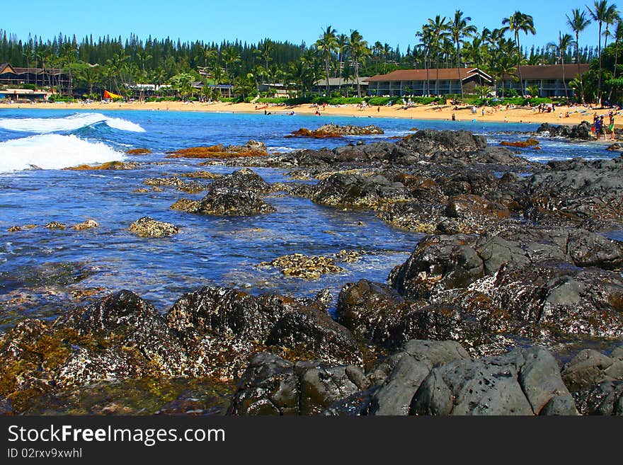 Waves crash on the shore in a tidal pool zone on the Hawaiian coast. Waves crash on the shore in a tidal pool zone on the Hawaiian coast.