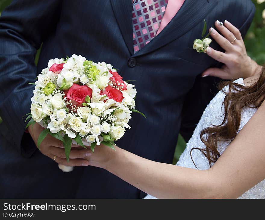 The groom with the bride hold a bouquet. The groom with the bride hold a bouquet