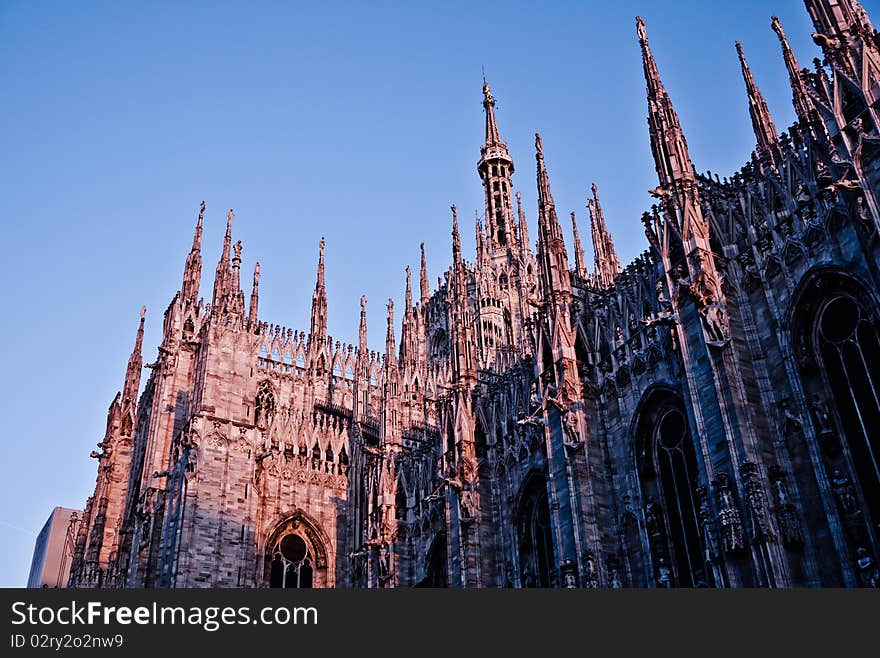 Milan Cathedral at sunset turns red against a blue sky, milan, Italy