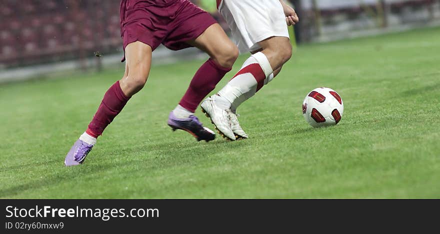 Soccer players running after the ball