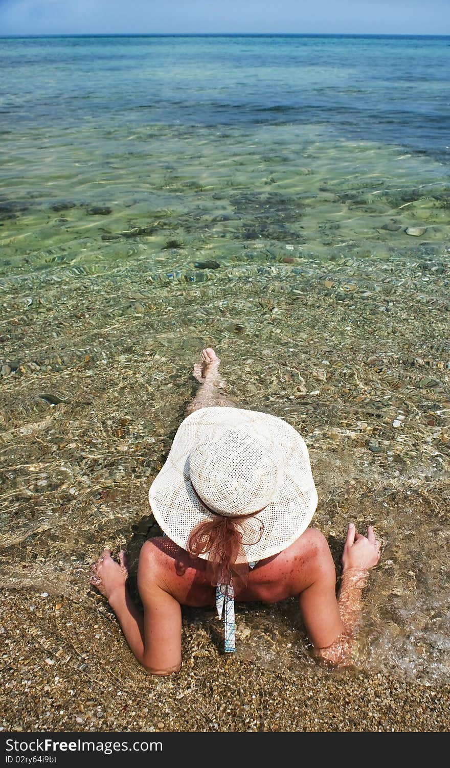 Woman with hat on the beach. Woman with hat on the beach