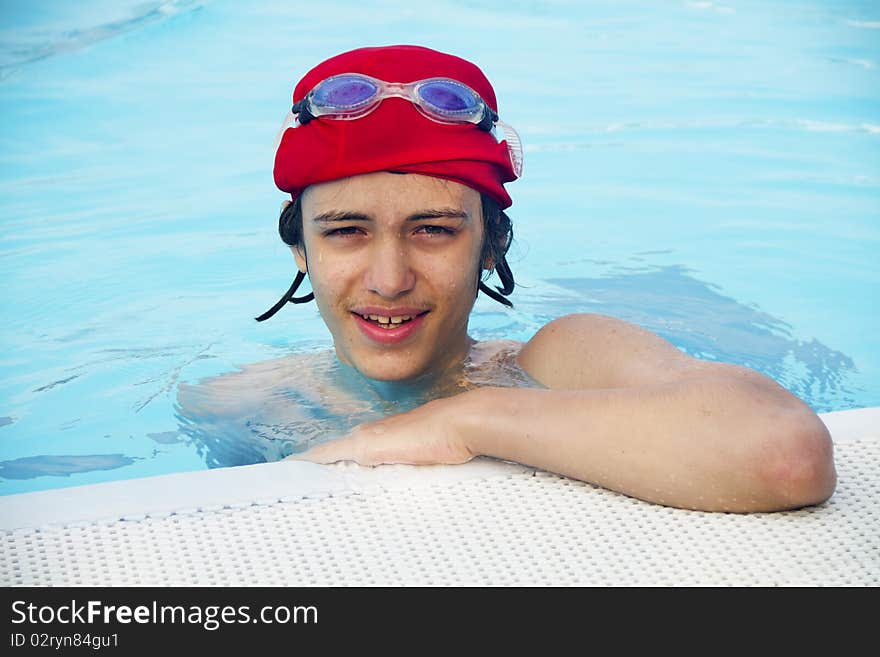 Boy in the swimming pool with the cap