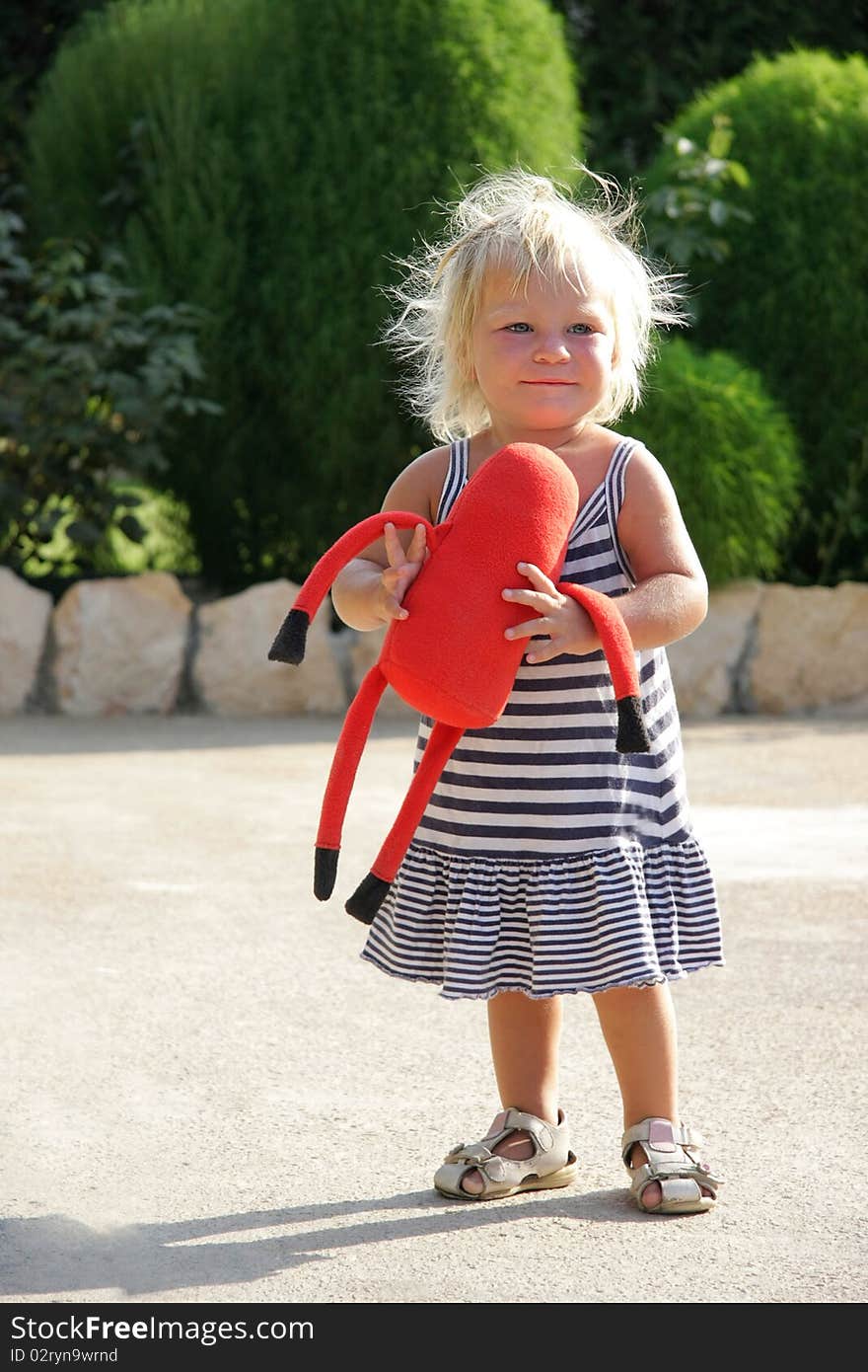 Adorable toddler girl walking outdoors. Adorable toddler girl walking outdoors