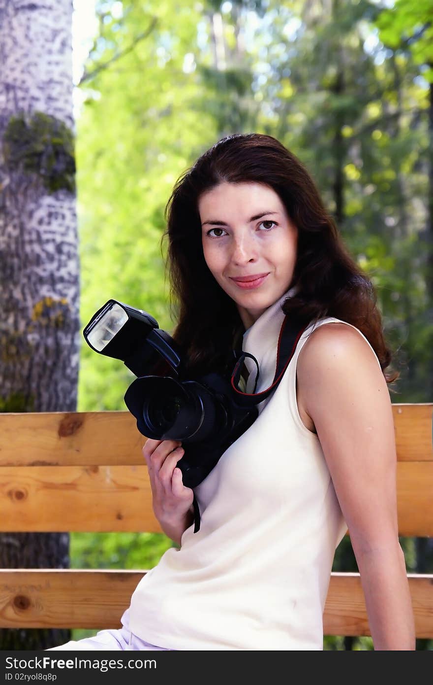 Photographer girl is sitting on the street. Photographer girl is sitting on the street