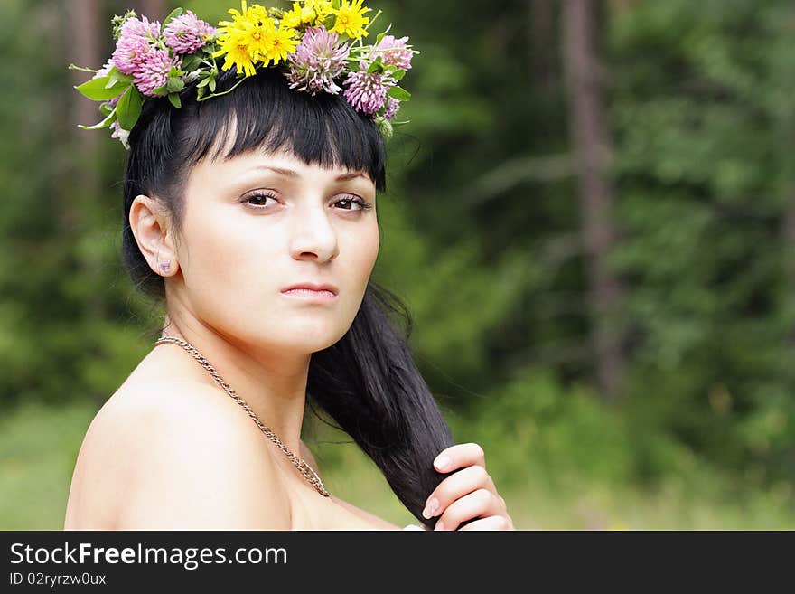 Portrait of a beautiful girl with flowers on head