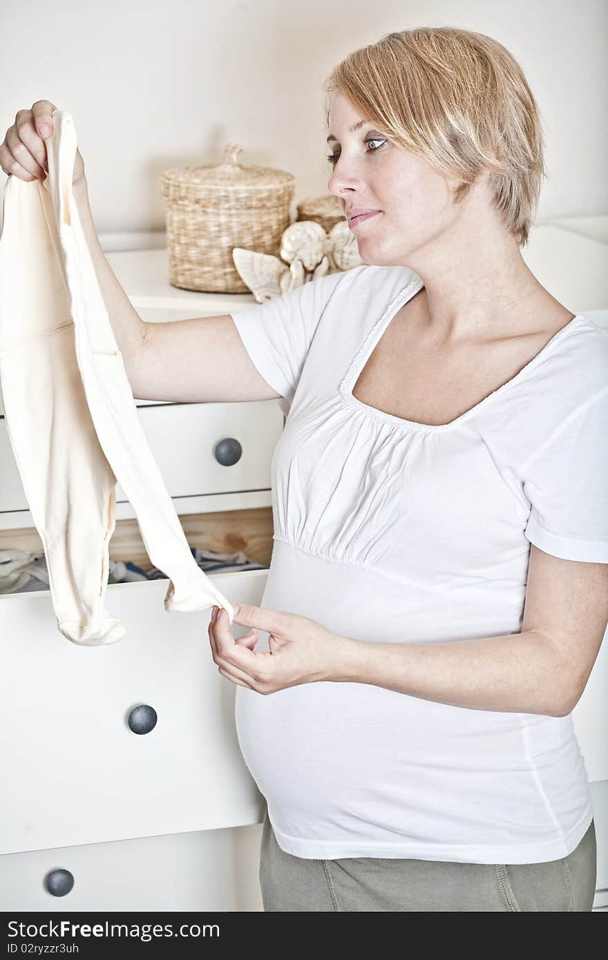 The mother prepares the baby-linen for the child