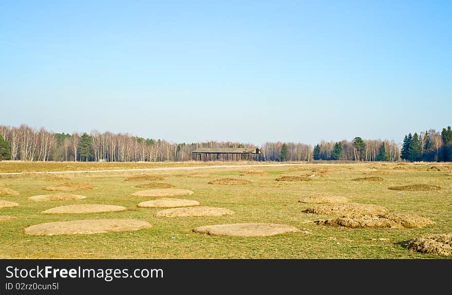 Landscape in the autumn field and piles of manure