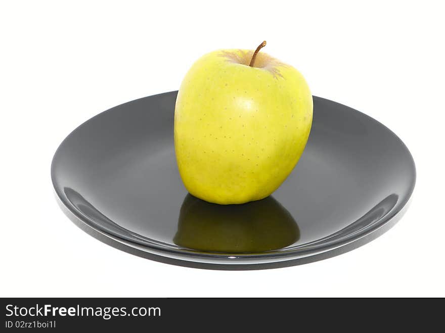 Green apple on the black plate