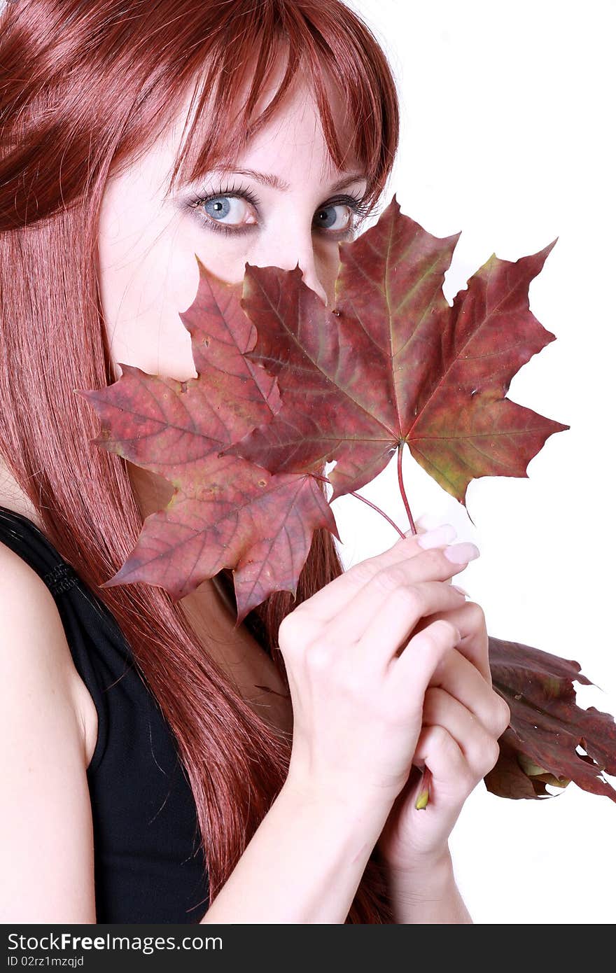 Beautiful young woman with red hair and maple leaves. Beautiful young woman with red hair and maple leaves