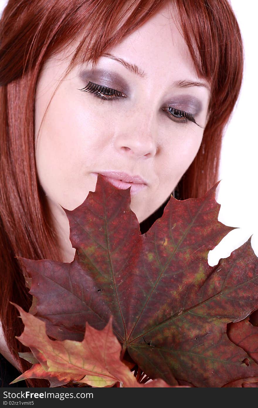 Beautiful young woman with red hair and maple leaves. Beautiful young woman with red hair and maple leaves