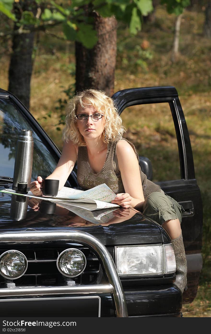 A woman driver reading a road map. A woman driver reading a road map