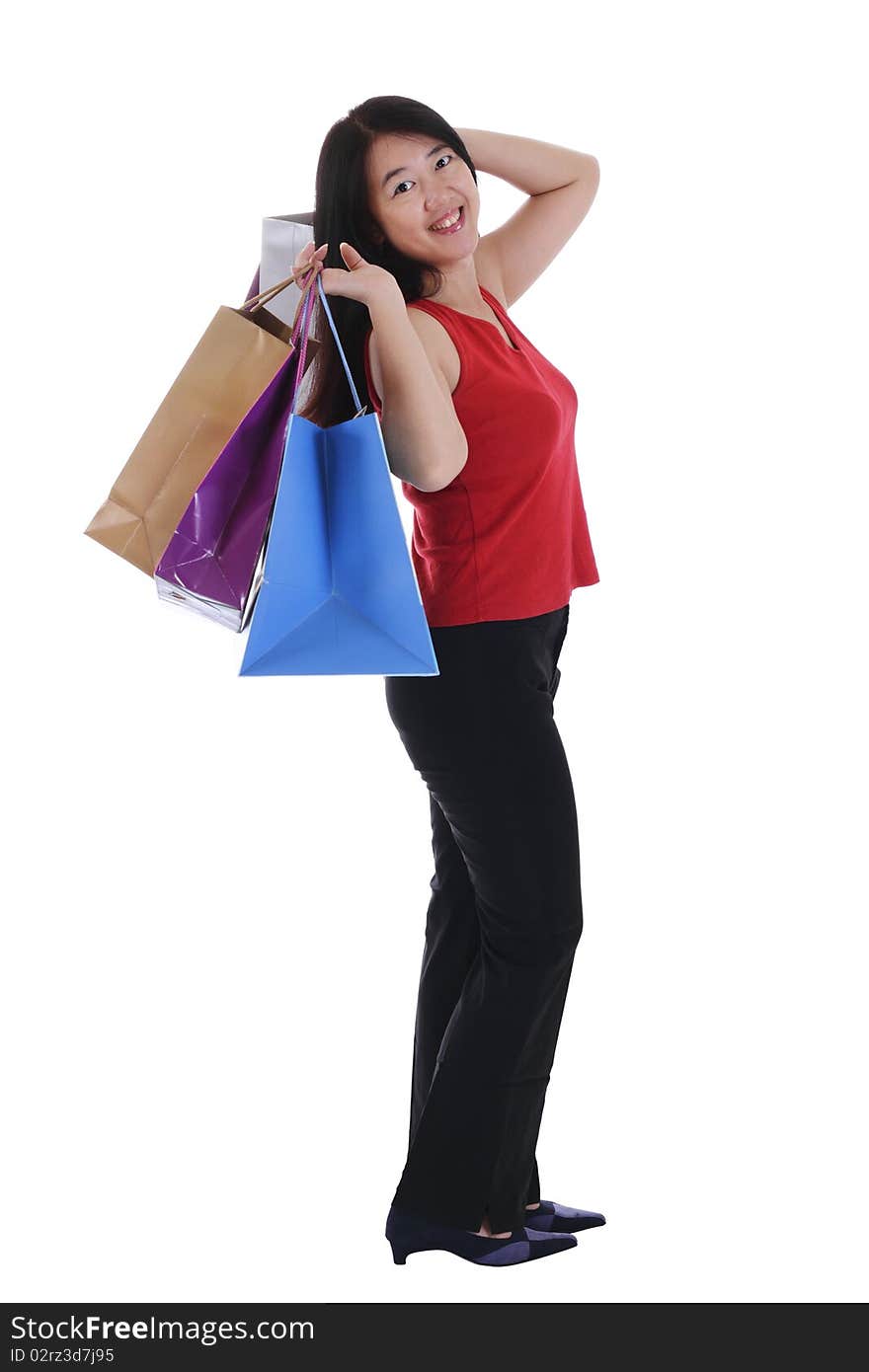 An Asian woman holding multiple shopping bags isolated in white background. An Asian woman holding multiple shopping bags isolated in white background