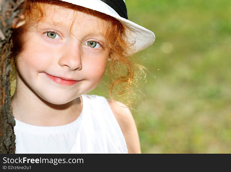 Portrait of a cute red-haired girl having a rest outdoor. Portrait of a cute red-haired girl having a rest outdoor.