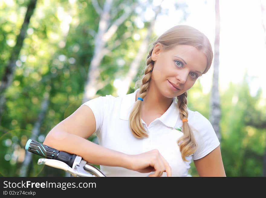 Young beautiful girl in a summer forest