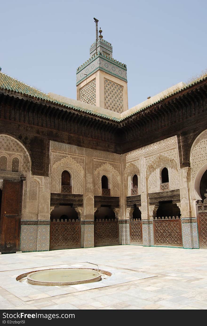 A minaret towers over the courtyard of this Koranic school in Fes. A minaret towers over the courtyard of this Koranic school in Fes