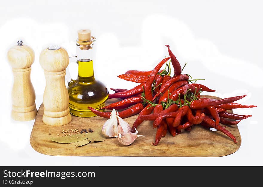 Pan, red pepper, garlic and spices on wooden board. Pan, red pepper, garlic and spices on wooden board