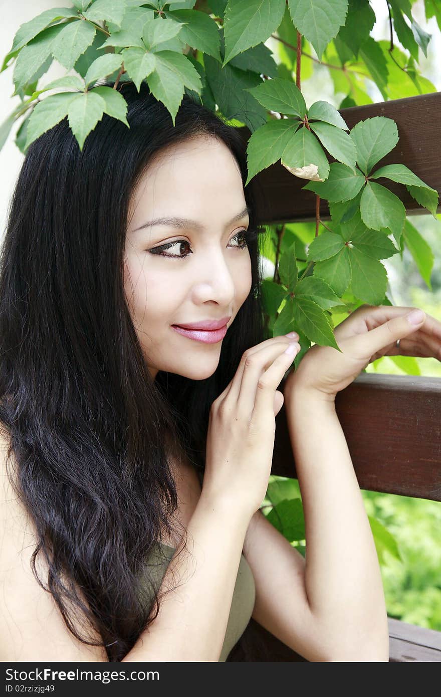 Beautiful Asian girl with long hair in the garden.(taken in August) She is a professional model. Beautiful Asian girl with long hair in the garden.(taken in August) She is a professional model.