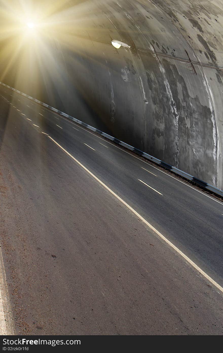 Bright electric light in a tunnel over road with the asphalted covering. Bright electric light in a tunnel over road with the asphalted covering