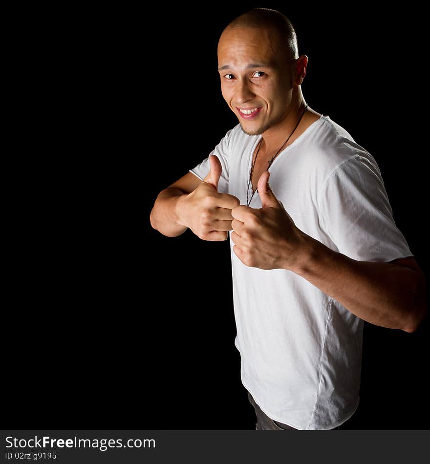 Young male filipino model over a black background is gesturing with his hand. Young male filipino model over a black background is gesturing with his hand.