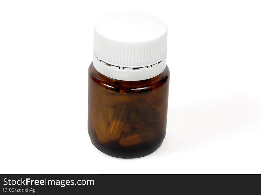 Glass bottle with pills isolated on white; including clipping path