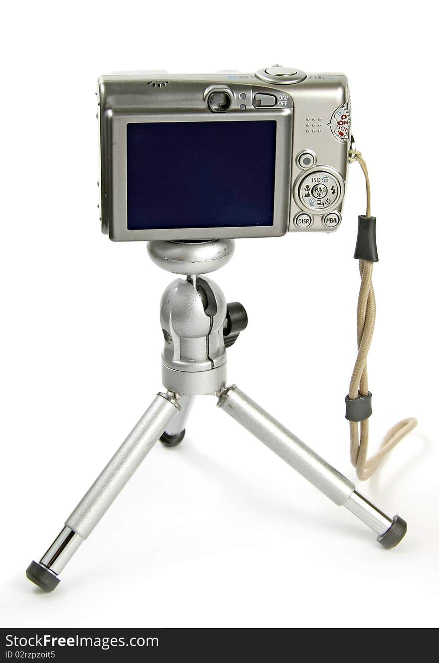 Digital small camera on tripod on white background with clipping path. Digital small camera on tripod on white background with clipping path