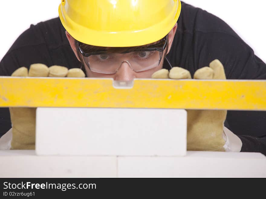 Construction worker with level on white background