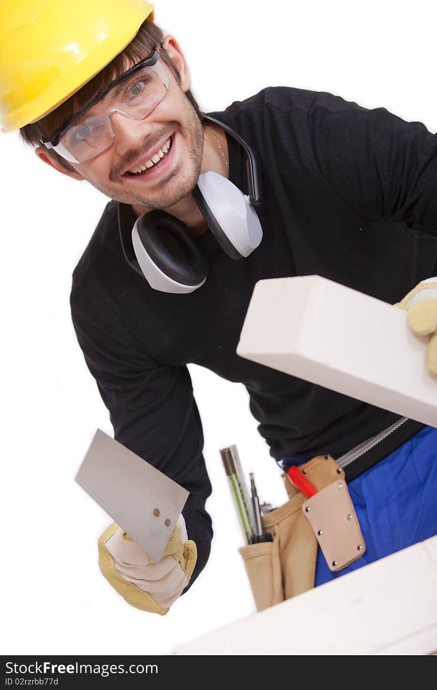 Happy professional bricklayer with spade - isolated on white background