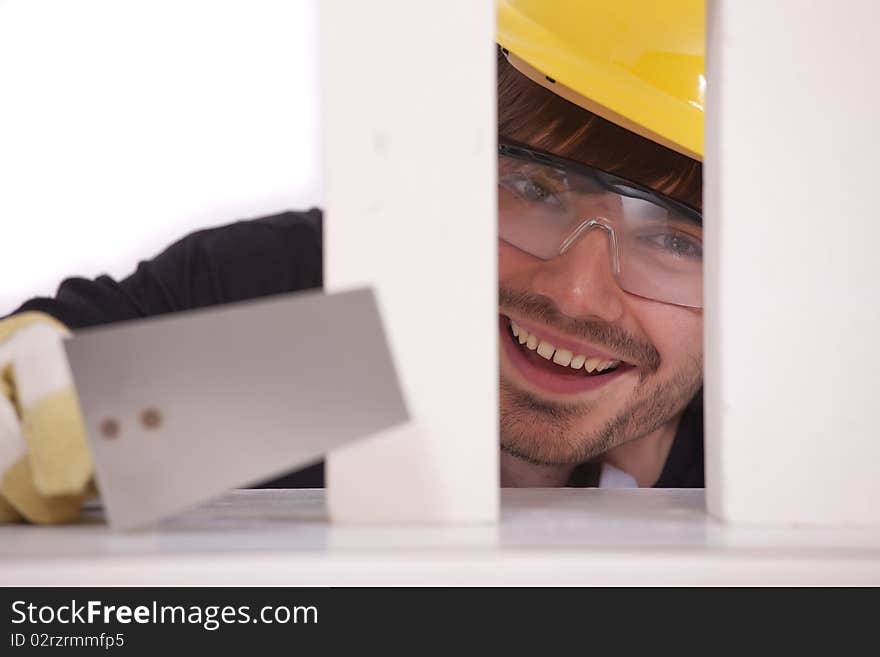 Happy bricklayer with spade and white brick stones