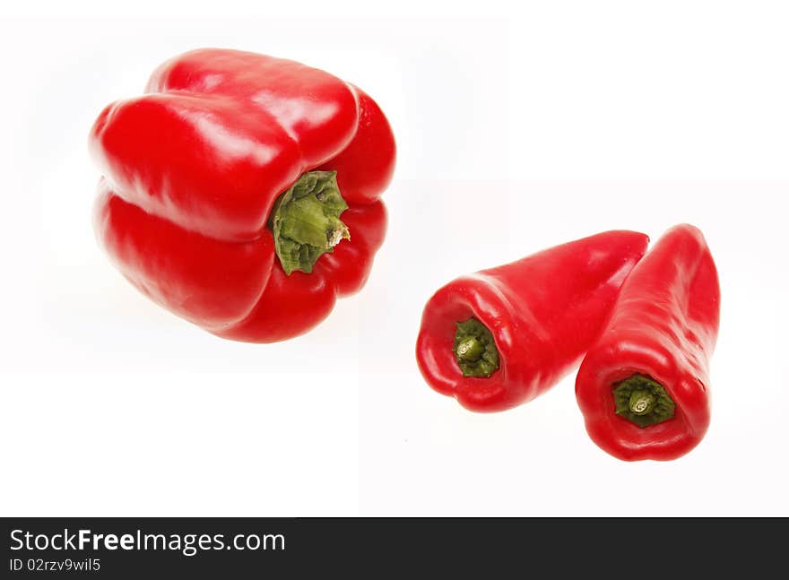 Ripe red peppers on white background.