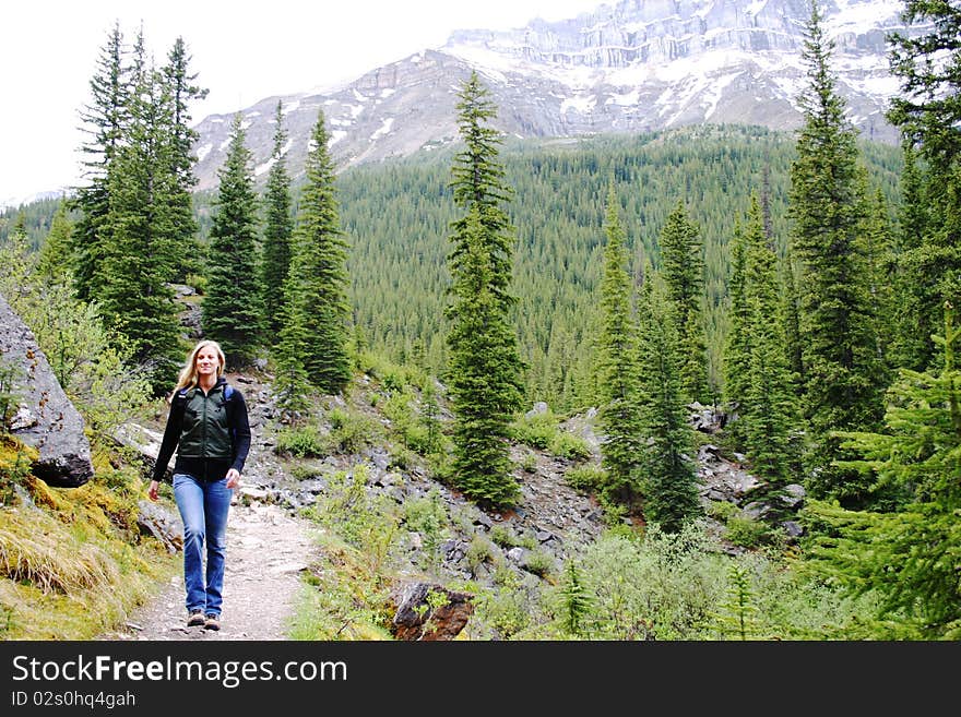 Hiker on a trail at Lake Moraine. Hiker on a trail at Lake Moraine