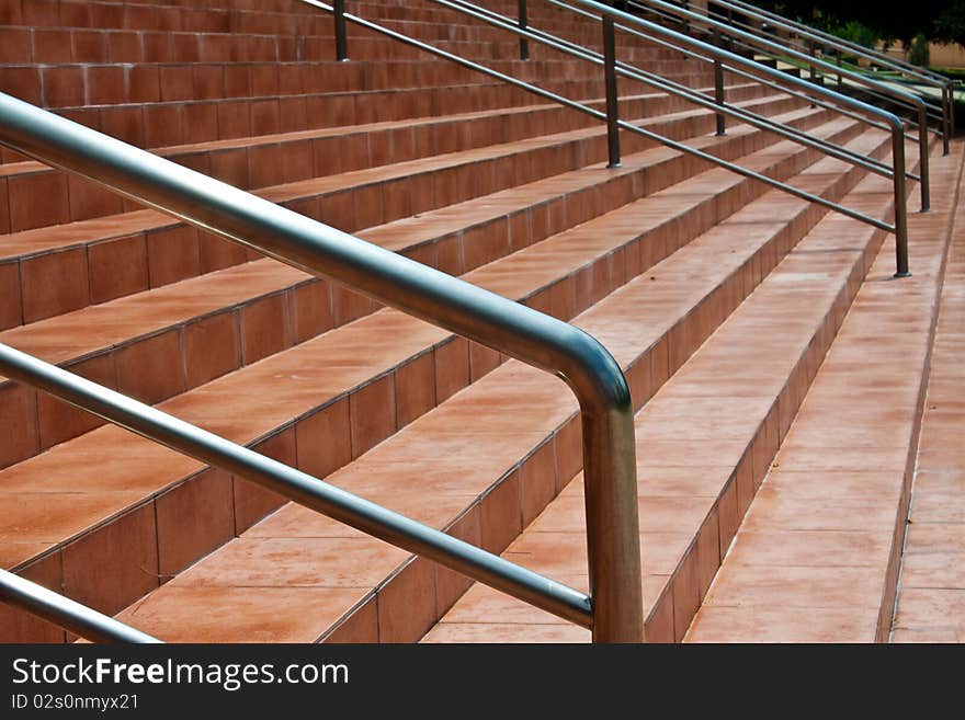 The brown stair have metal handle