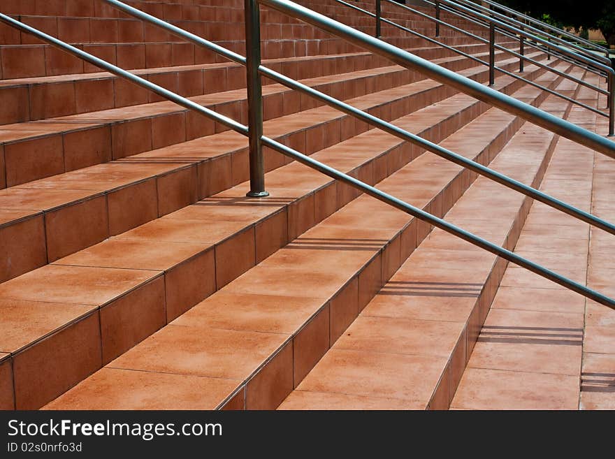 The brown stair have metal handle