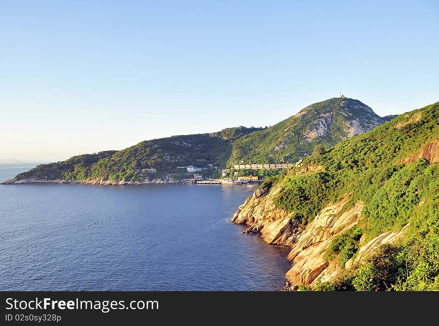 Sunset ray on an islands with buildings,blue sea and sky. Sunset ray on an islands with buildings,blue sea and sky