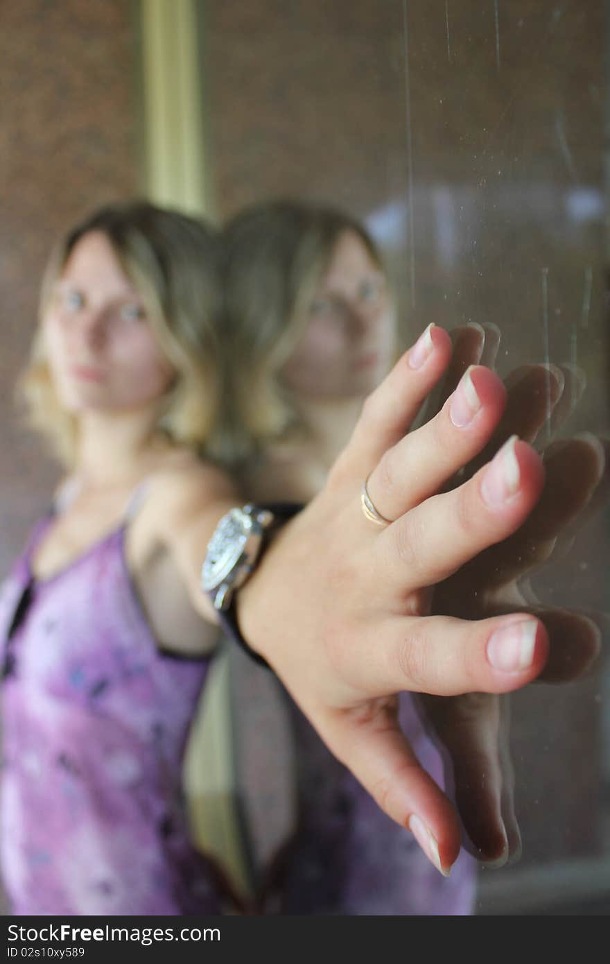 Woman's hand near the mirror