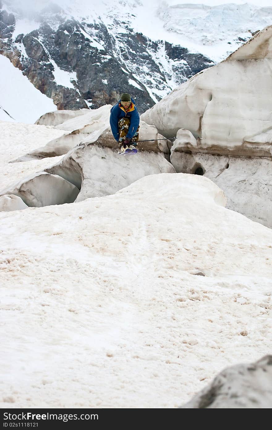 Freerider jumping in a mountains, Caucasus, Elbrus, summer