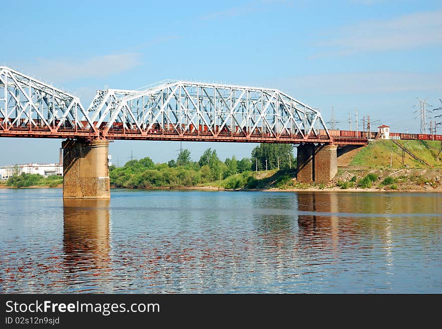 Railway bridge with freight train over the Volga river, Russia