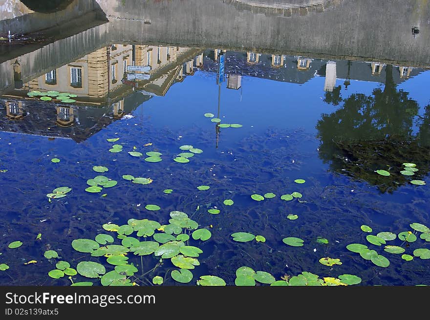 Houses being reflected in the quiet water of the river which crosses the city of Metz, France. Houses being reflected in the quiet water of the river which crosses the city of Metz, France.