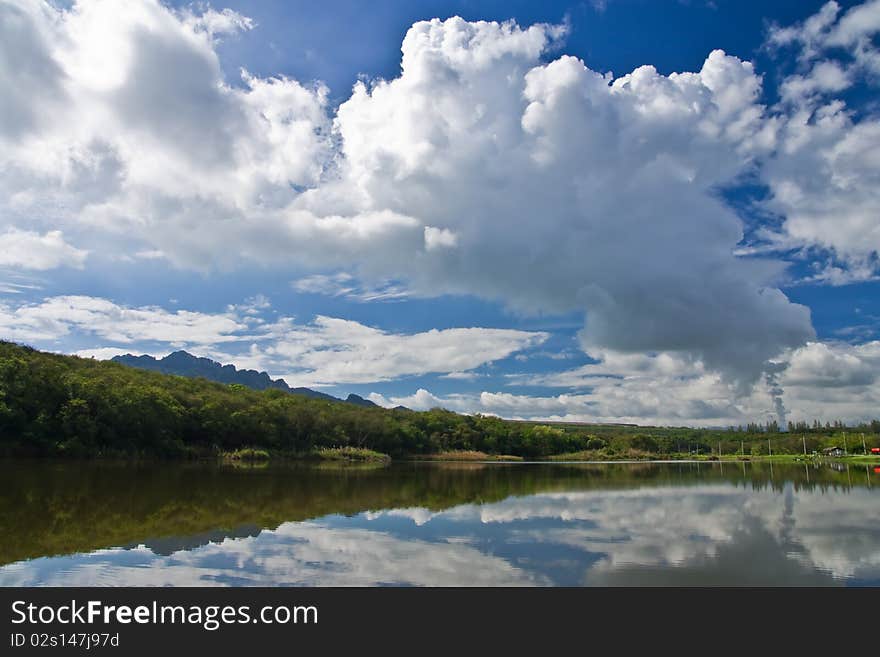 Smoke from electric plant reflect in water