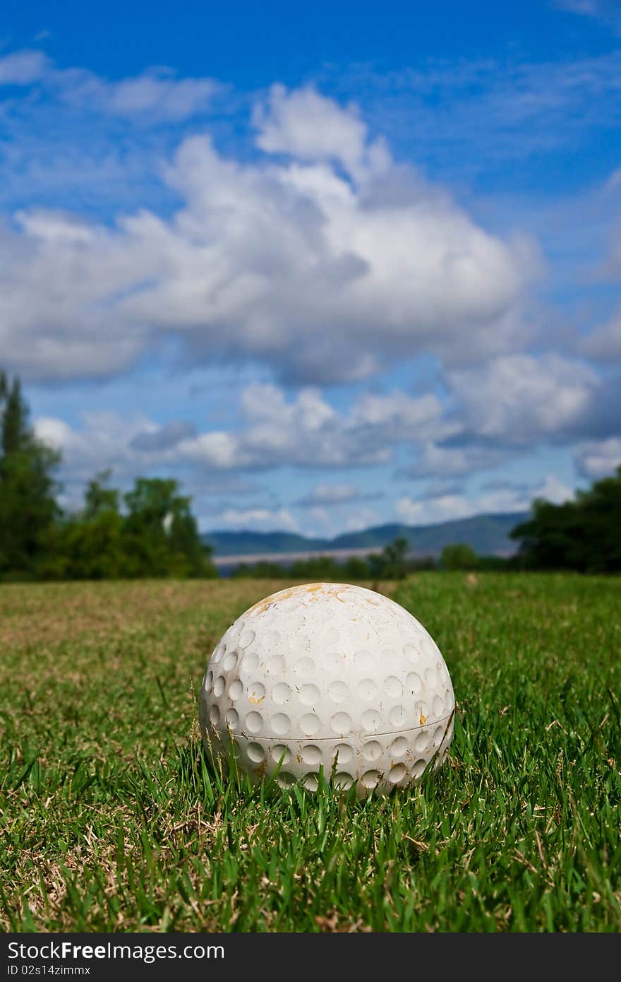 Golfball On Course And Blue Sky